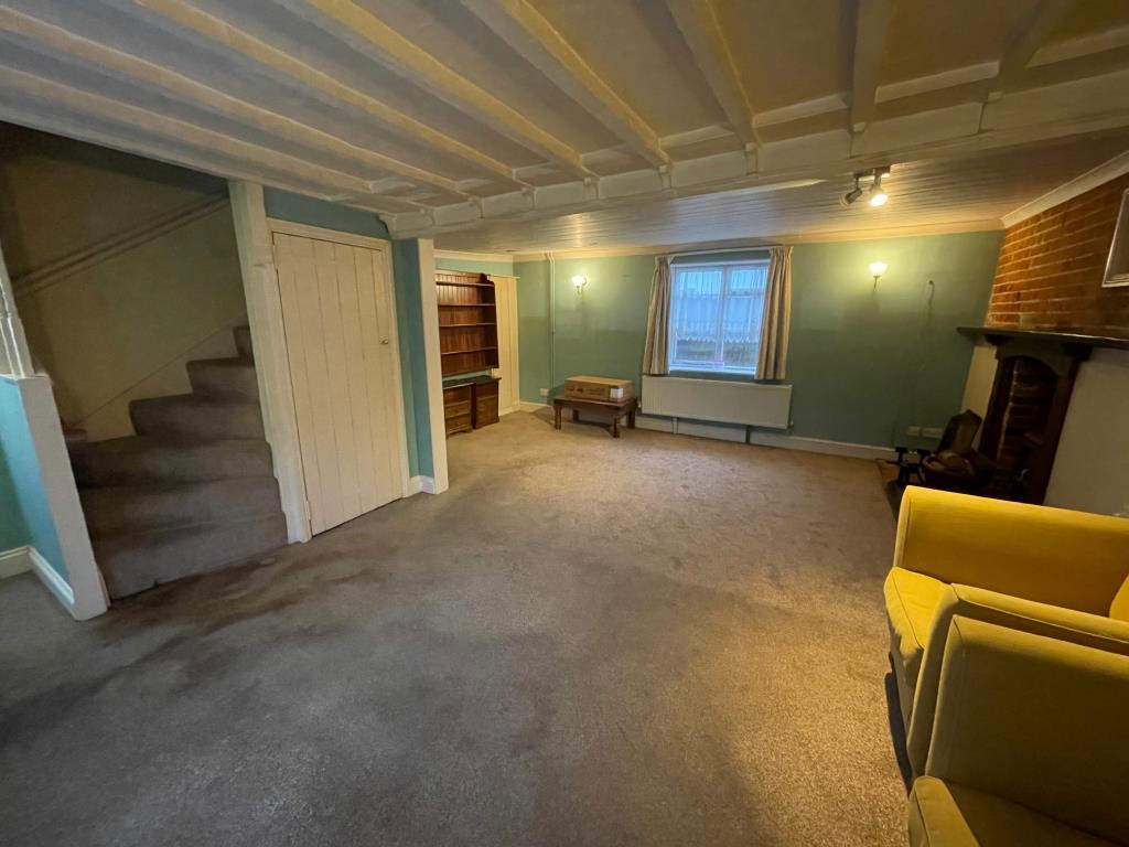 Lot: 132 - CHARACTER COTTAGE IN ESSEX VILLAGE LOCATION - Alternative view of living room and stairs